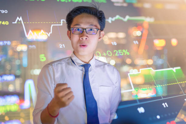 istock Young business man using laptop and digital tablet cityscape background 645864412