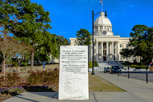 Memorial marker for the Selma to Montgomery Voting Rights March with the Alabama State Capitol in the background.