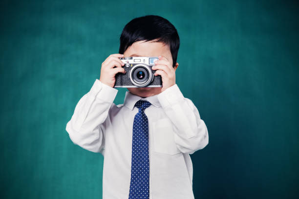 istock Young Boy Accountant Watches Money Fall from Sky 645872358