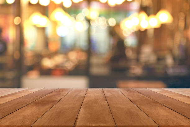 istock Blurred image of restaurant with bokeh lights background and wood table 645896660