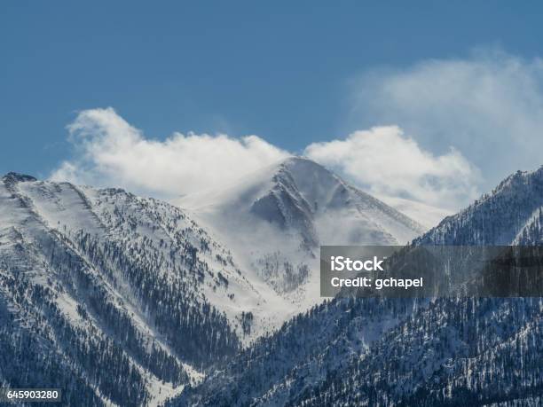 Windswept Snow Covered Mountain Peak In Northern Nevada Near Reno Nevada With Clouds And A Blue Sky Stock Photo - Download Image Now