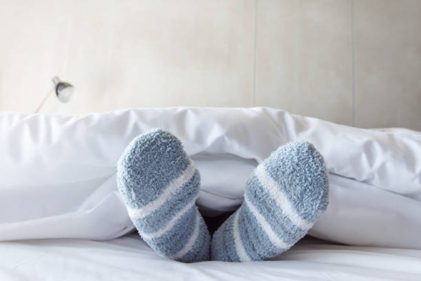 istock Female foot in warm Stripe wool sock 645903426