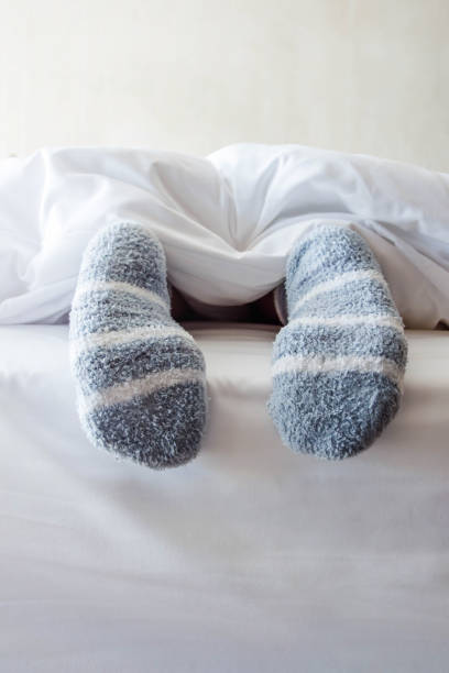 istock Female foot in warm Stripe wool sock 645903600