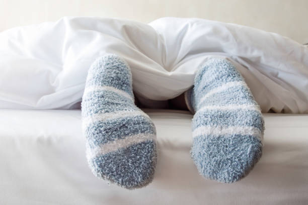 istock Female foot in warm Stripe wool sock 645905468