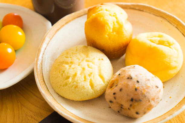 istock Bread and lots of fresh bread buns on a wooden table 645941732