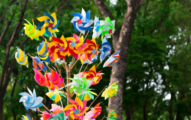 istock Many fun colorful pinwheels spinning in the wind at a carnival park. 645945512