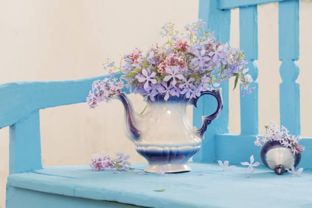 istock still life with spring flowers on blue bench 645948076