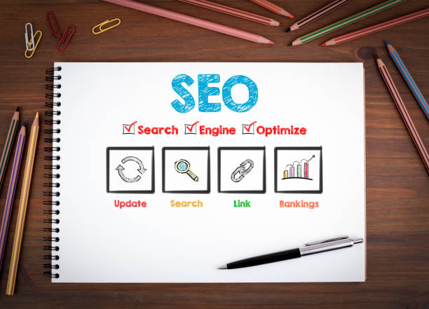 istock SEO concept. Notebooks, pen and colored pencils on a wooden table 645948706