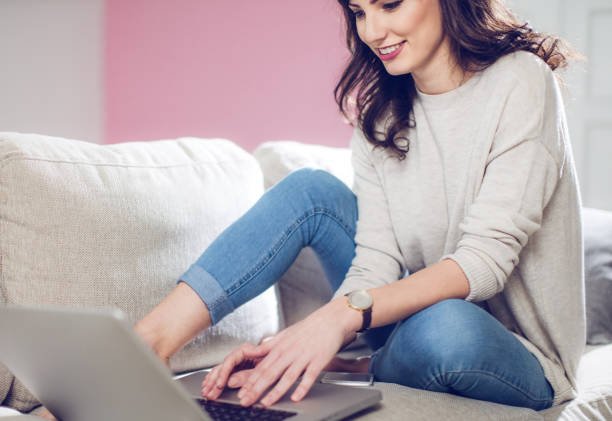 istock Happy girl using laptop at home 645949476