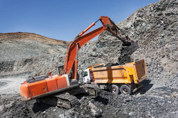 istock Excavator loading truck in mine area 645949544
