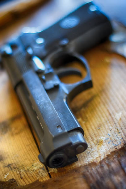 istock Old gun on wooden background 645952408