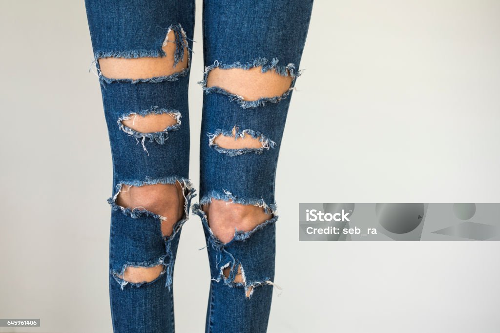 Woman in fashionable ripped Jeans Jeans Stock Photo