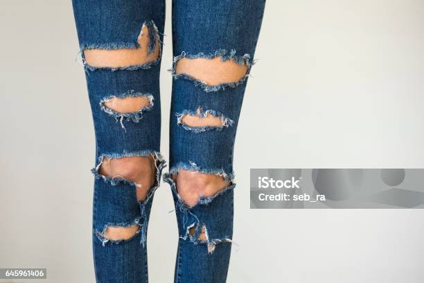 Woman In Fashionable Ripped Jeans Stock Photo - Download Image Now - Jeans, Torn, Hole