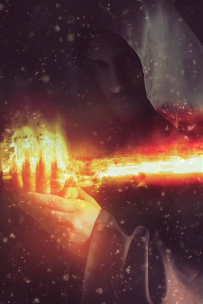 istock Young warrior holding a saber in fire 645961844