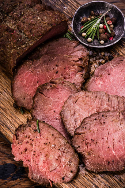 istock Roast beef on cutting board with salt and pepper. Top view. 645964536