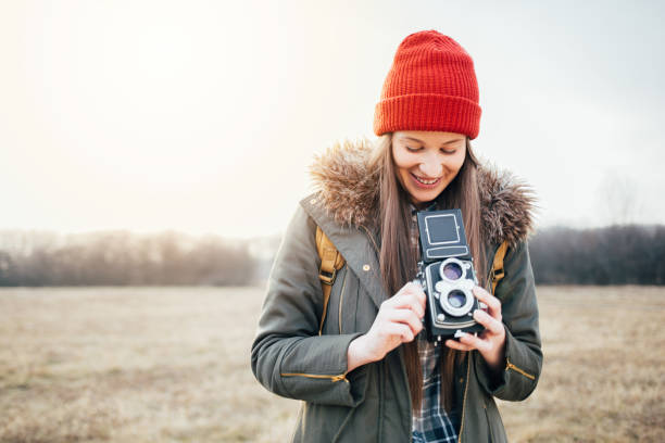 istock Young woman holding vintage camera 645965116