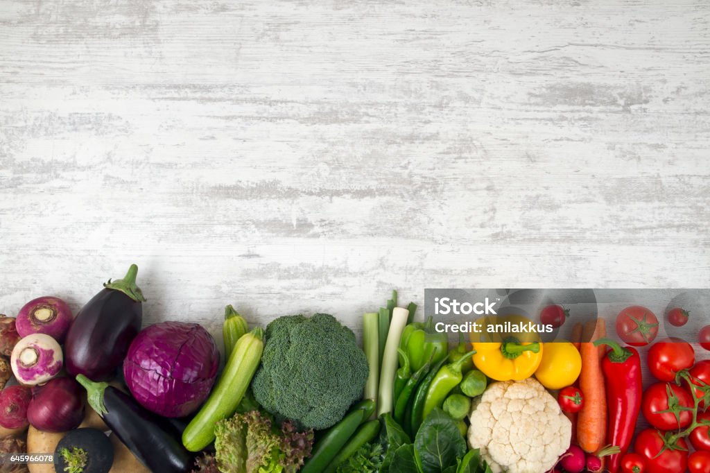 Healthy Food Background Red,green, and yellow fresh vegetables on white wood background. Vegetable Stock Photo