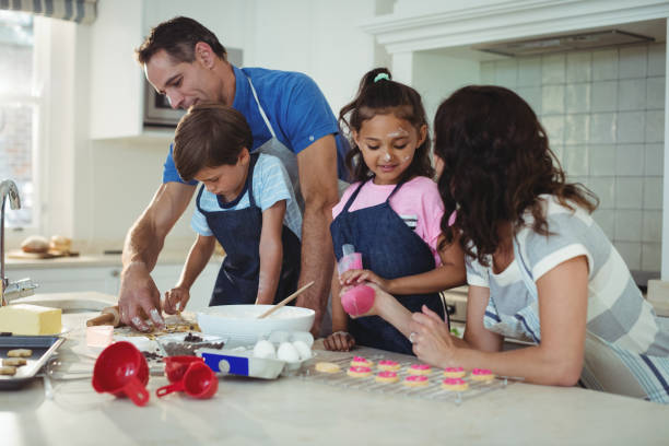 istock Happy family preparing cookies in kitchen 645968936