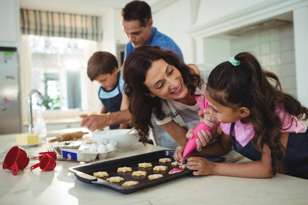 istock Happy family preparing cookies in kitchen 645971204