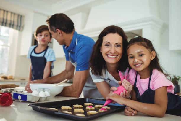 istock Happy family preparing cookies in kitchen 645971264