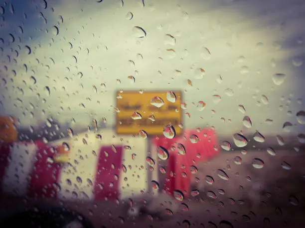View of a rainy day through a slow moving car.