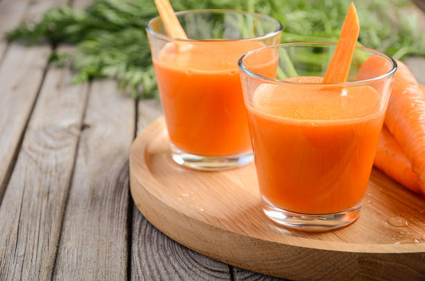 istock Fresh carrot juice on wooden background 645974164