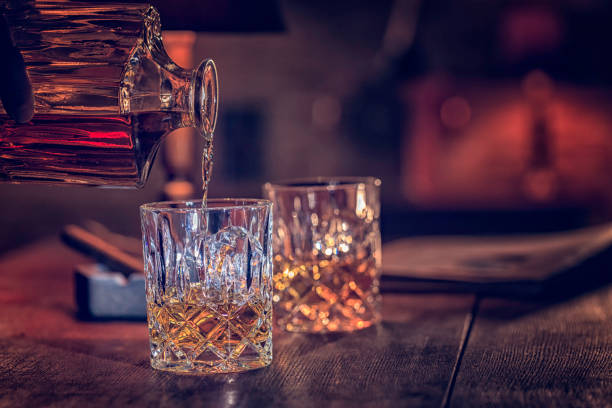 Glass of Whiskey with ice Glass of scotch whiskey served with ice brandy photos stock pictures, royalty-free photos & images