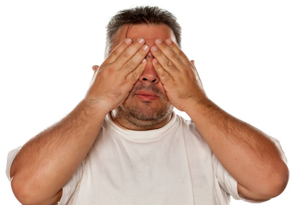 istock a fat man covering the eyes with his hands 645981060