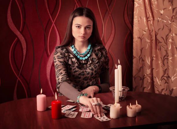 istock Young woman with divination cards in room 645984730