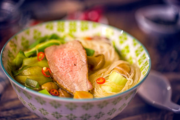 Asian glass noodle soup with roasted beef, bok choy, spring onions, ginger, chili and lemon grass.