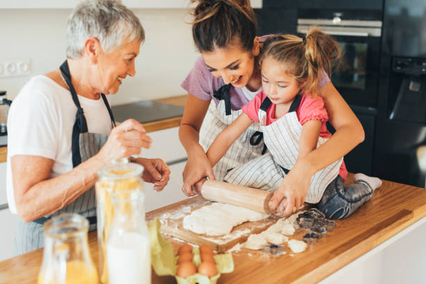 istock Mother teaching her daughter to make cookies 645994376