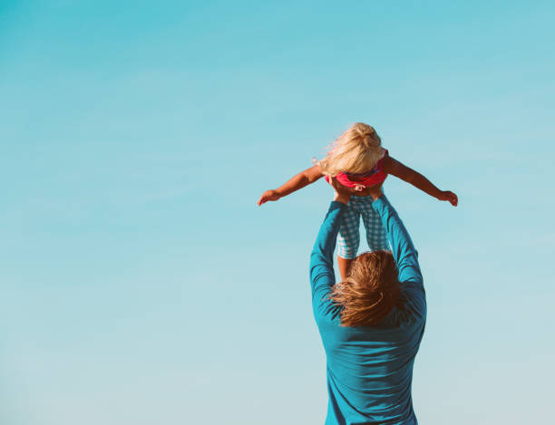 istock Father and little daughter play at sky 645996948