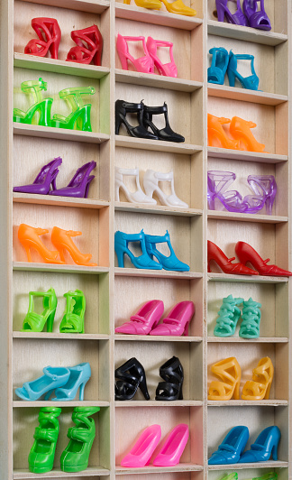 Close up plastic doll shoe closet withcolorful high heel pumps and sandals