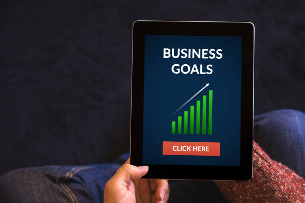 istock Hands holding tablet computer with business goals concept on screen 645997632