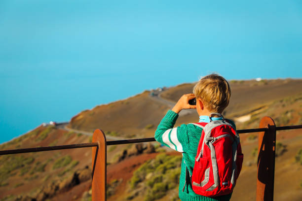 istock little boy looking at beautiful view while travel in mountains 645997646