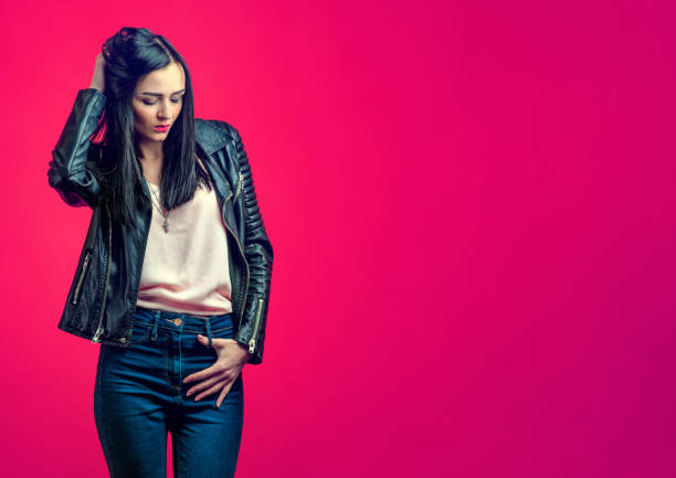 istock Brooding stylish girl with black hair in a leather jacket 646001896