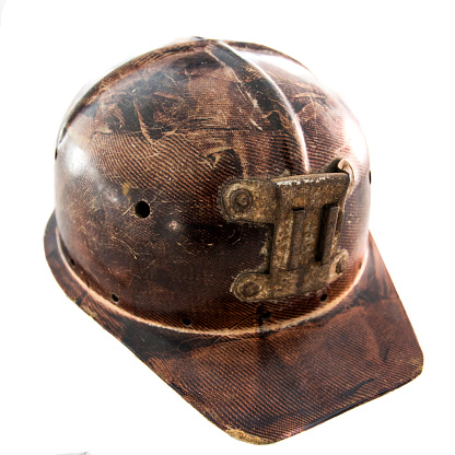 Old mining helmet isolated on white