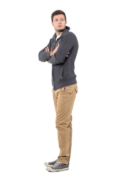 istock Side view of young man with crossed arms looking back 646008316