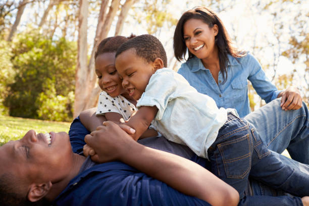 istock Parents Playing With Children On Grass In Summer Park 646011520