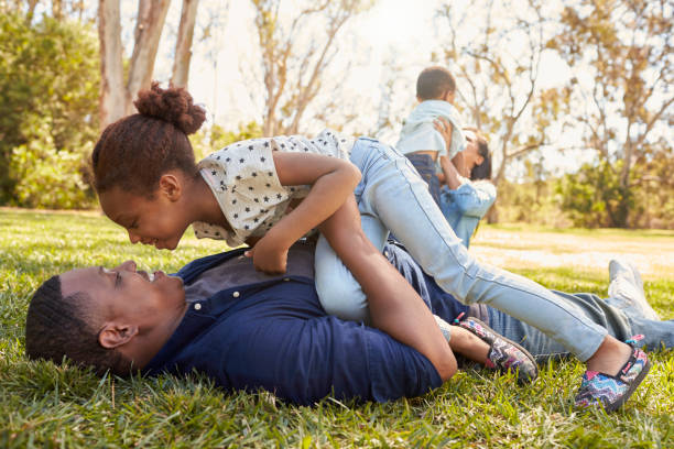 istock Parents Playing With Children On Grass In Summer Park 646011532