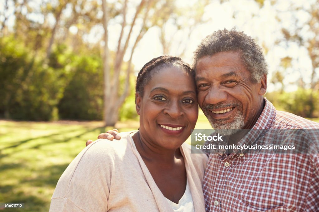 Outdoor Head And Shoulders Portrait Of Mature Couple In Park African-American Ethnicity Stock Photo