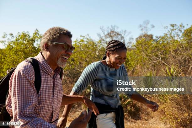 Mature Couple Hiking Outdoors In Countryside Together Stock Photo - Download Image Now