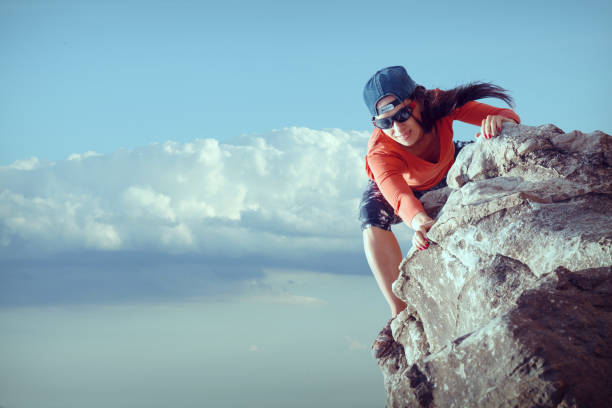 young girl tourist looks for way from the top of the rock