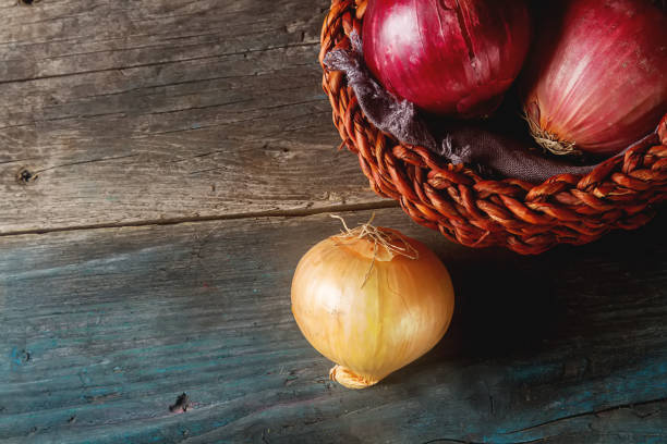 istock Onions of different varieties and colors. Dark gray background. 646020712