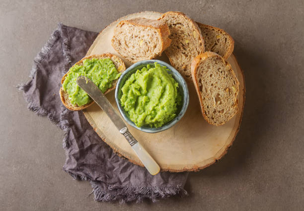 istock Baguette with mashed green peas and mint. Dark background. Selec 646023500