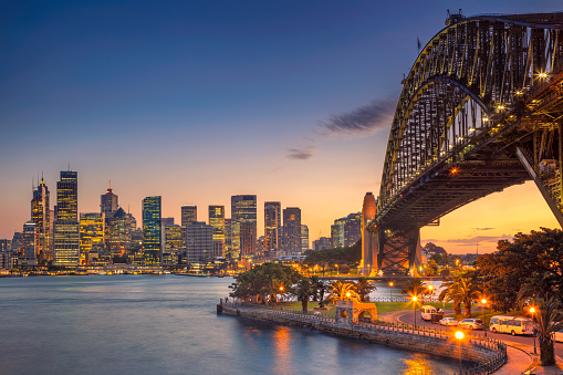 Cityscape image of Sydney, Australia with Harbour Bridge during summer sunset.