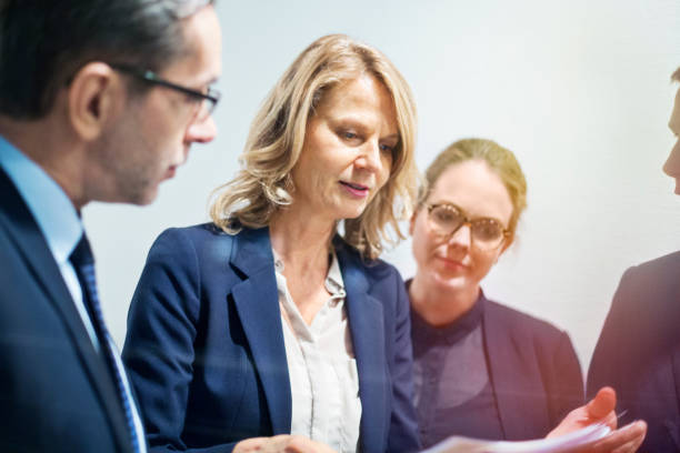 istock Mature businesswoman discussing reports with colleagues 646029062