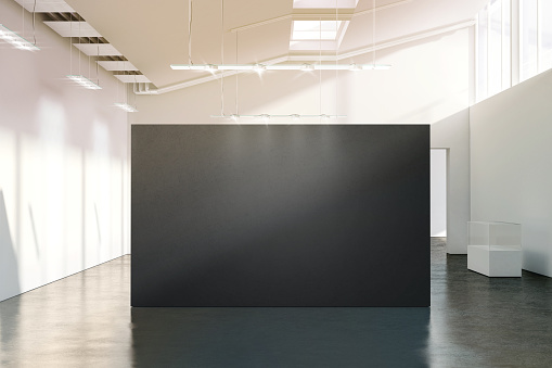 Blank black wall mockup in sunny modern empty gallery