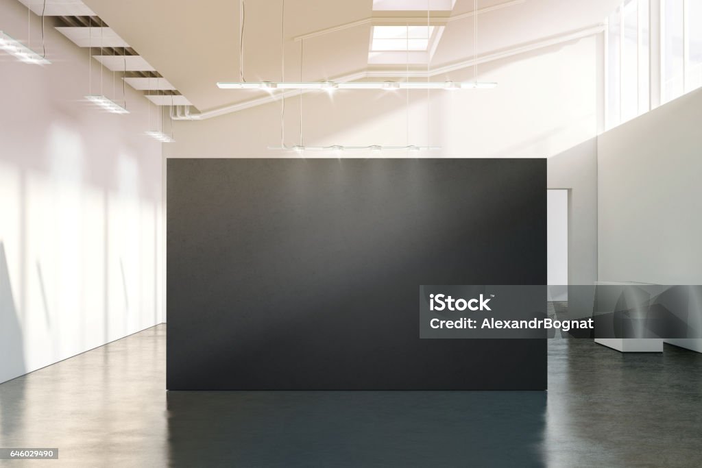 Blank black wall mockup in sunny modern empty gallery Blank black wall mockup in sunny modern empty gallery, 3d rendering. Dark big stand mock up in museum with contemporary art exhibitions. Large hall interior with wide grey banner exposition template. Wall - Building Feature Stock Photo