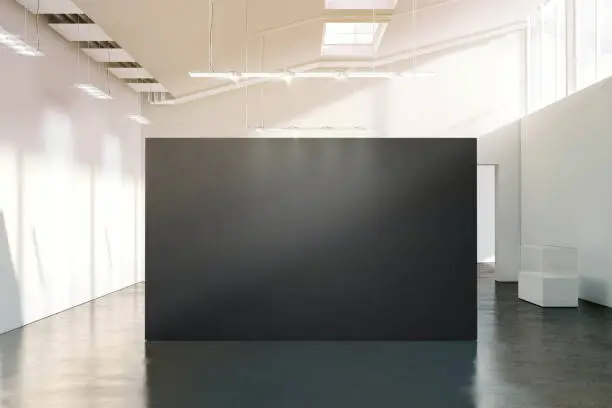 Photo of Blank black wall mockup in sunny modern empty gallery